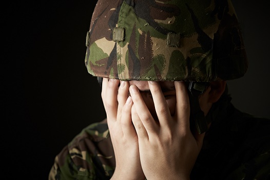 Soldier In Uniform Suffering From Stress